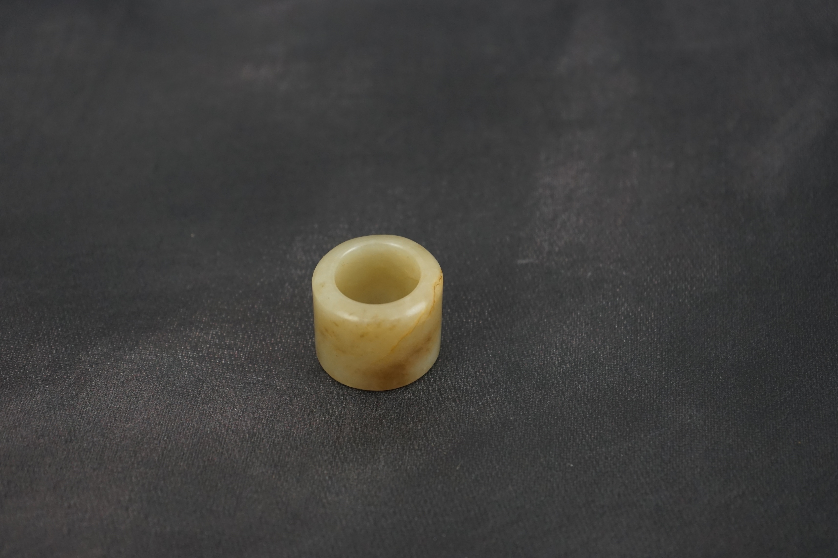 A Chinese pale celadon jade archer's thumb ring, 18th/19th century